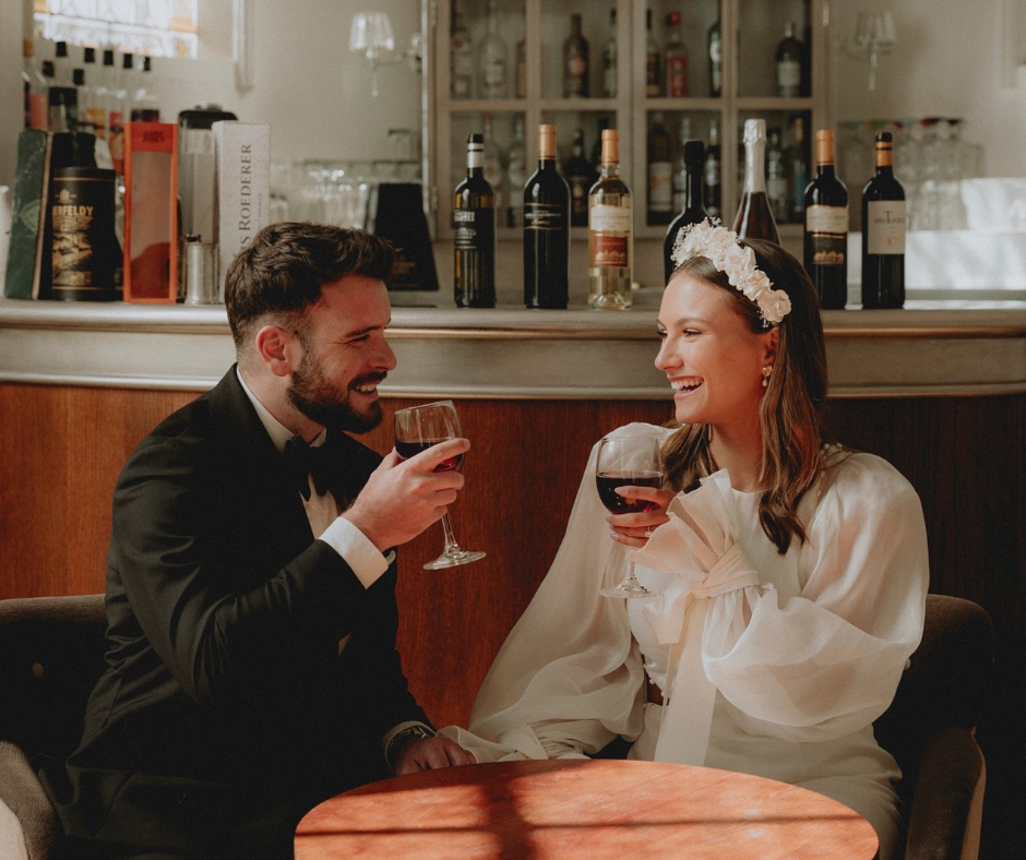 Bride and Groom drinking red wine in the stylish art deco style bar at Chateau de la Cazine