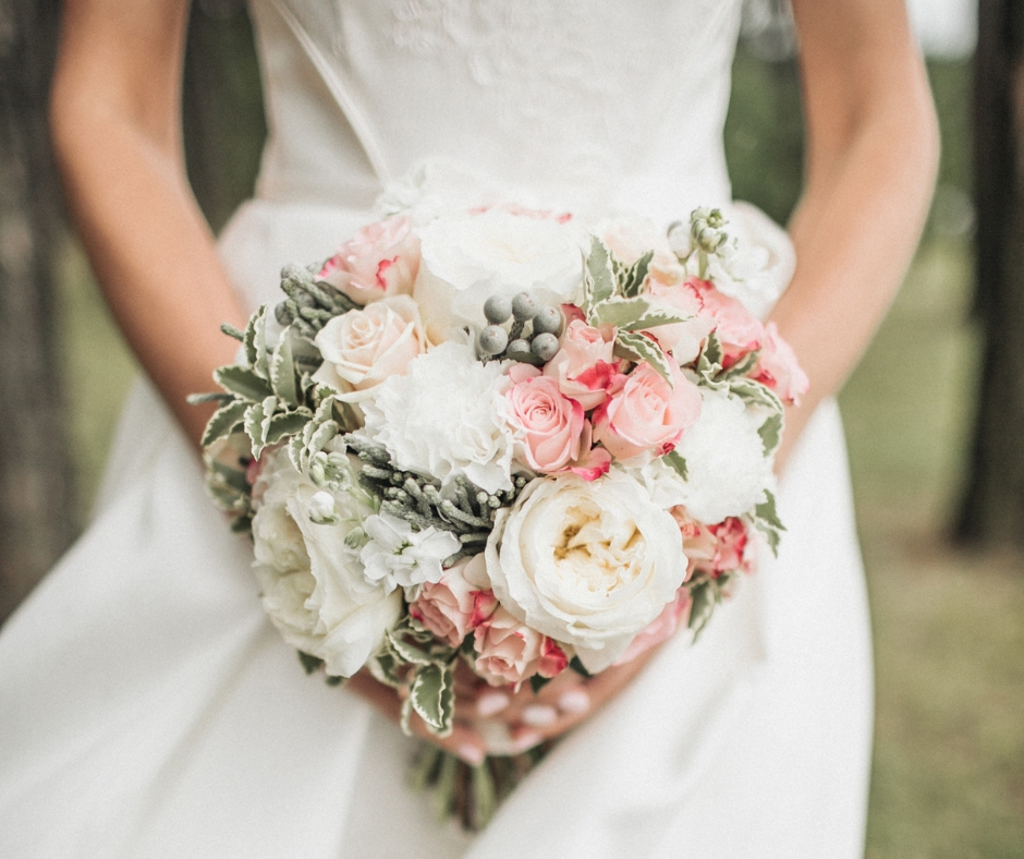 Heart Shape pink and creamy bridal bouquet held by a bride