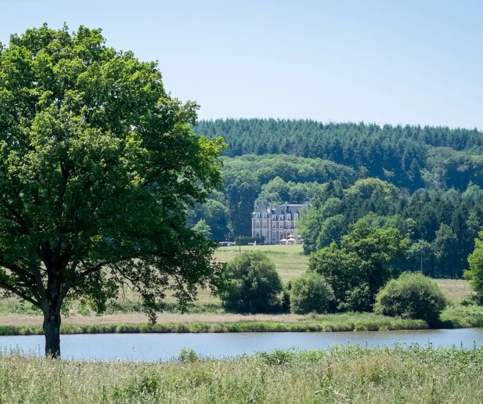 Chateau de la Cazine from a distance in front of the Petite Cazine Lake