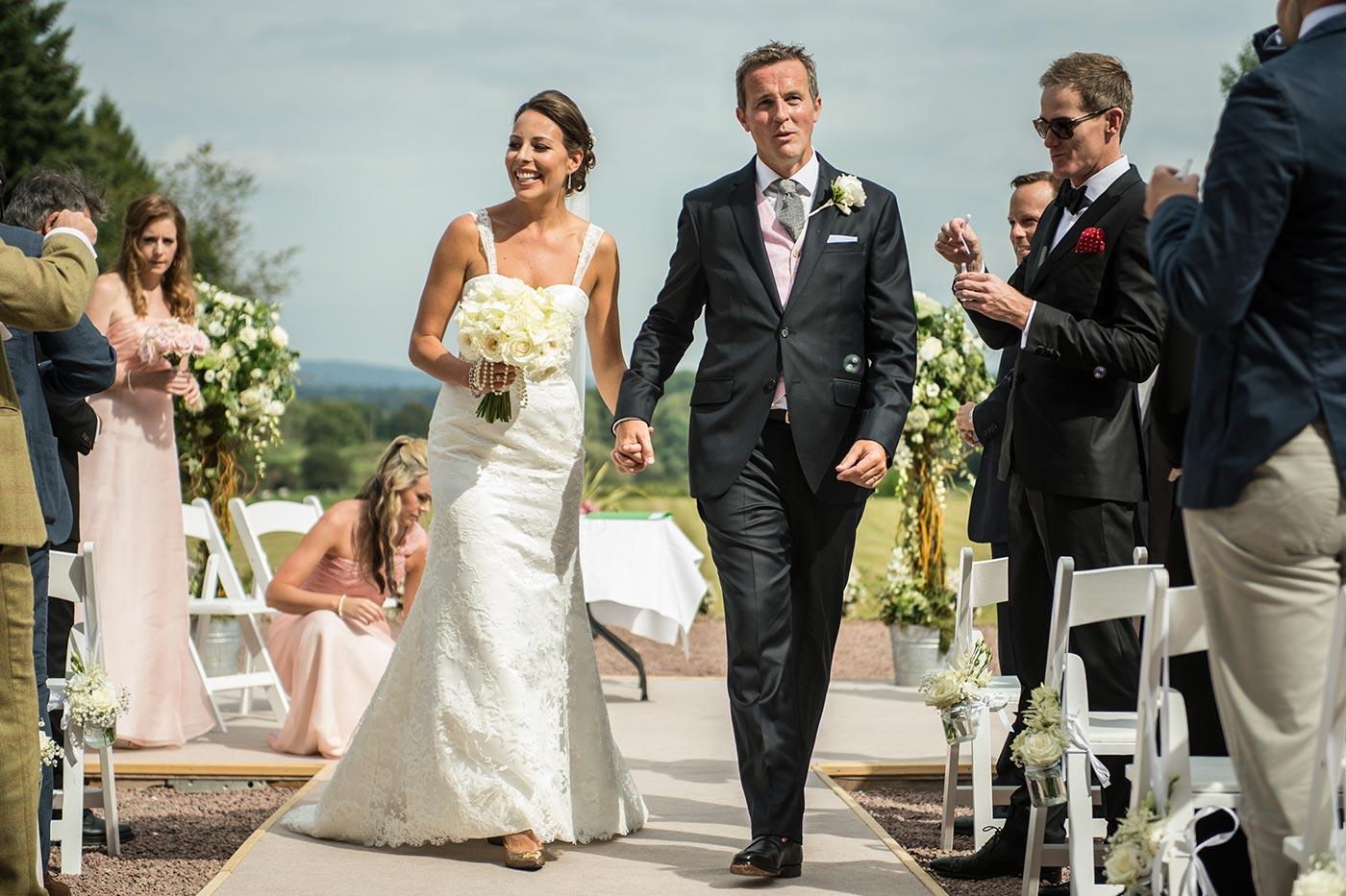 Couple walking down their aisle during their outdoor wedding ceremony at Chateau de la Cazine